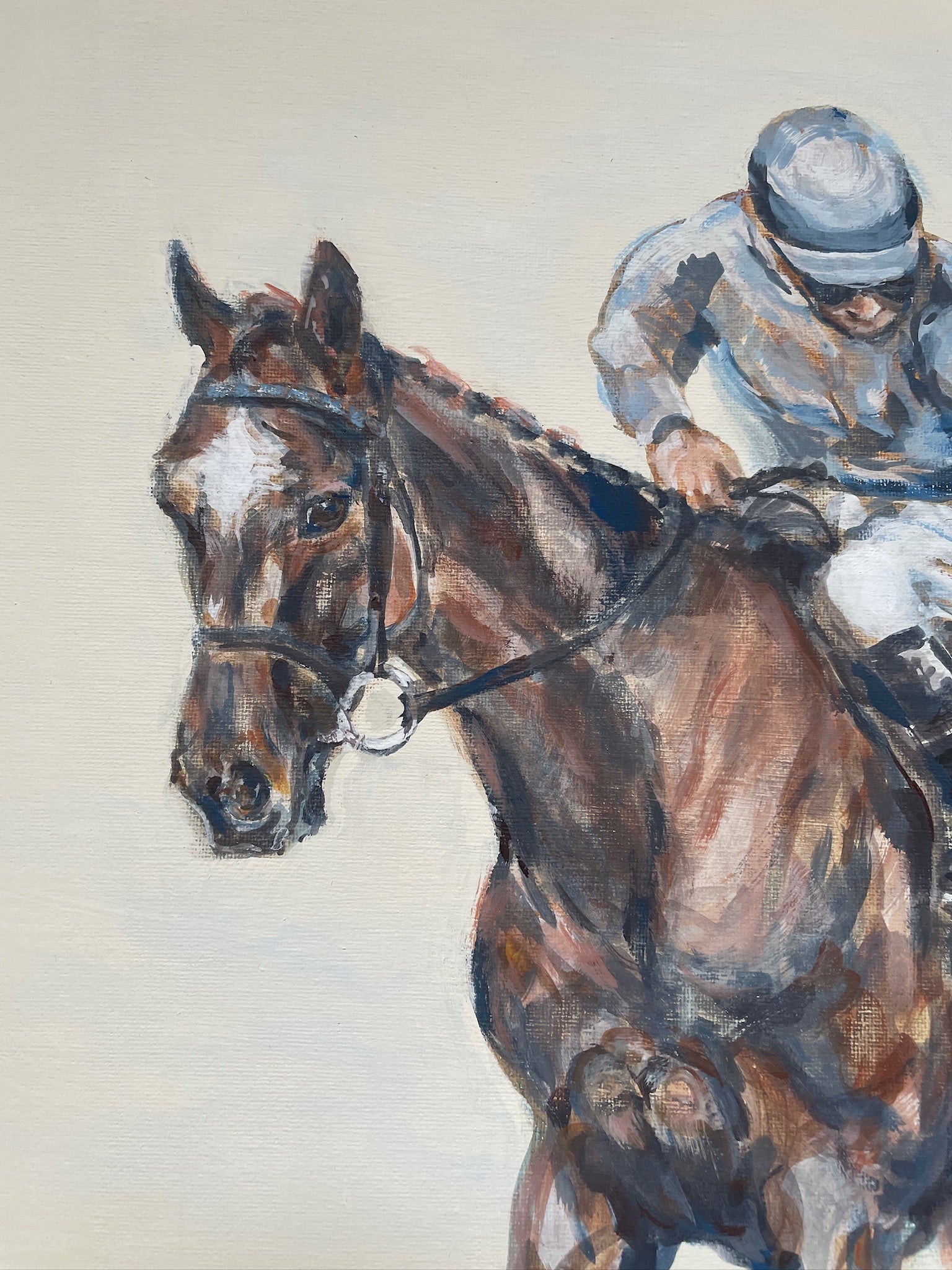 This painting is the study of a jockey checking his girth before the start of the race. The composition is from an interesting angle of perspective and the muted palette accentuates the quiet ritual of the preparatory checks before the thrilling act of horseracing.
