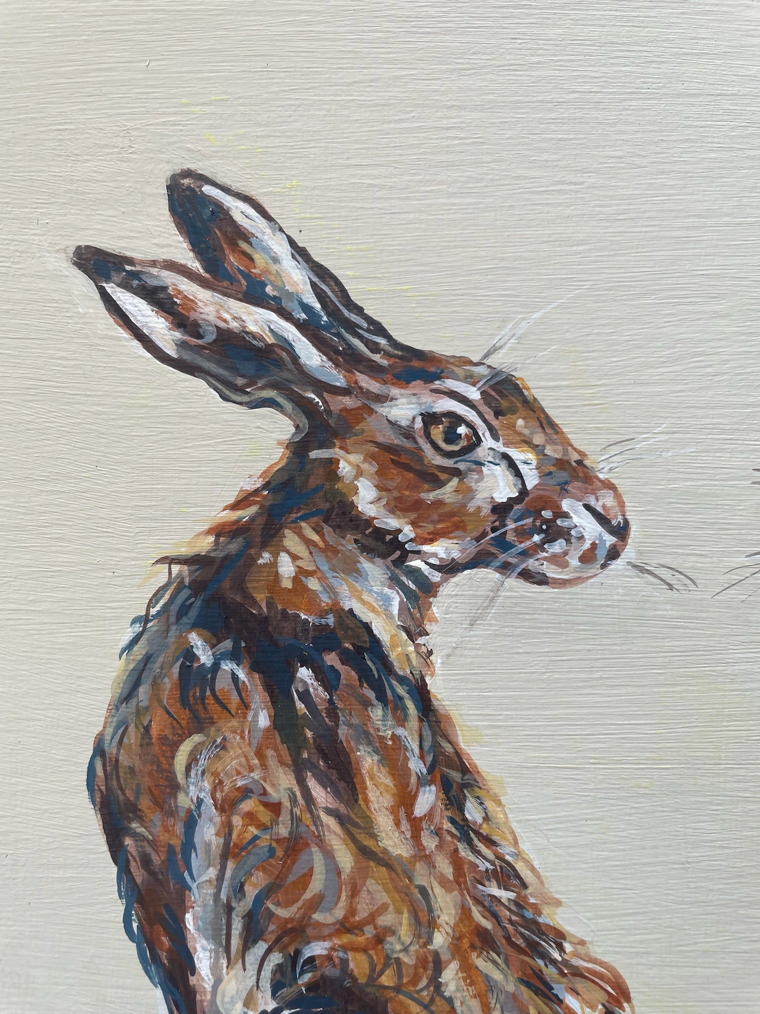 This painting features two hares in a heart shaped composition. These characterful hares have been spied before they leap across the countryside meadow.