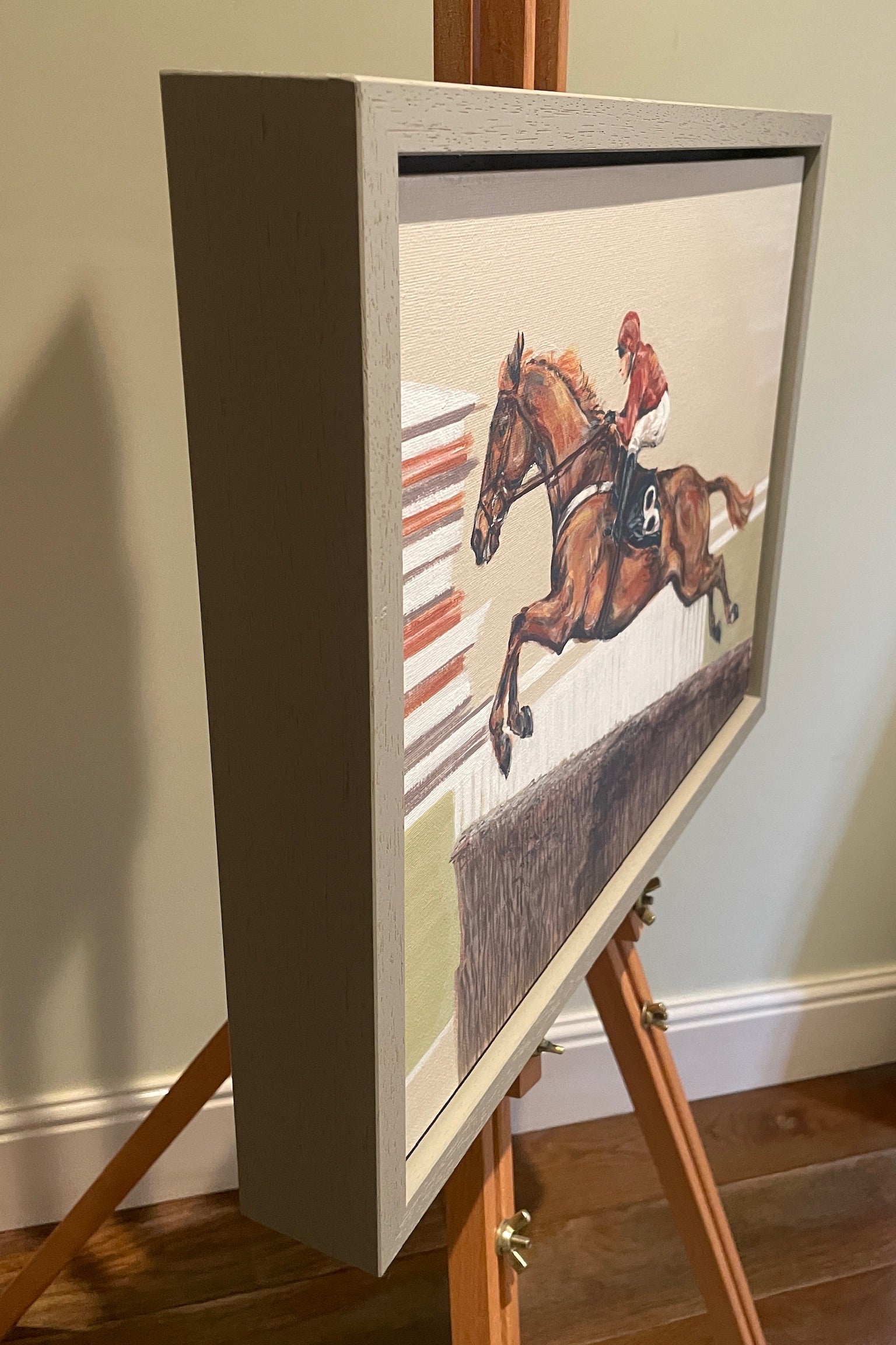 This painting has a racehorse over jumps as the subject. Power Surge depicts the power of the horse jumping at speed.