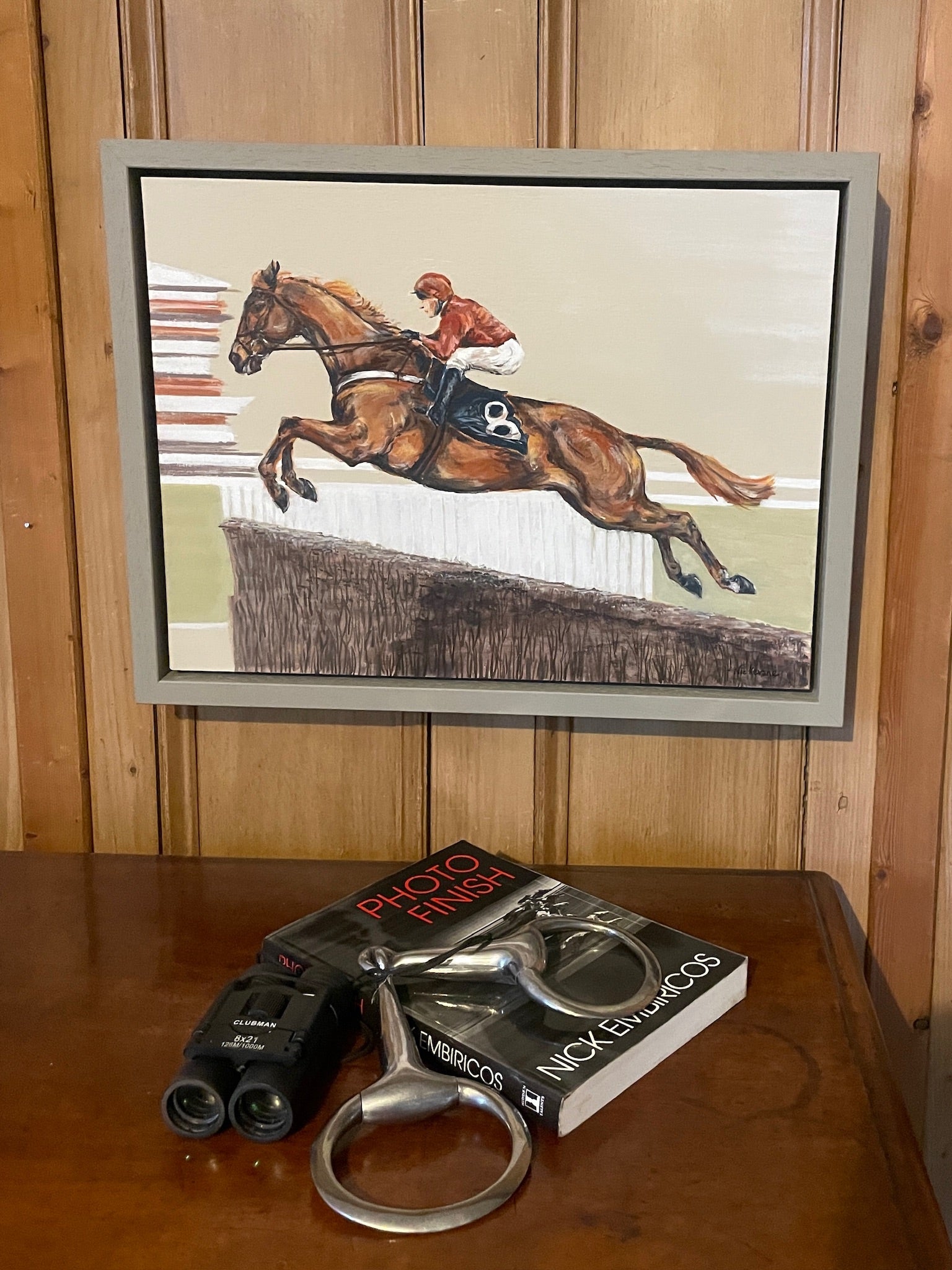 This painting has a racehorse over jumps as the subject. Power Surge depicts the power of the horse jumping at speed.
