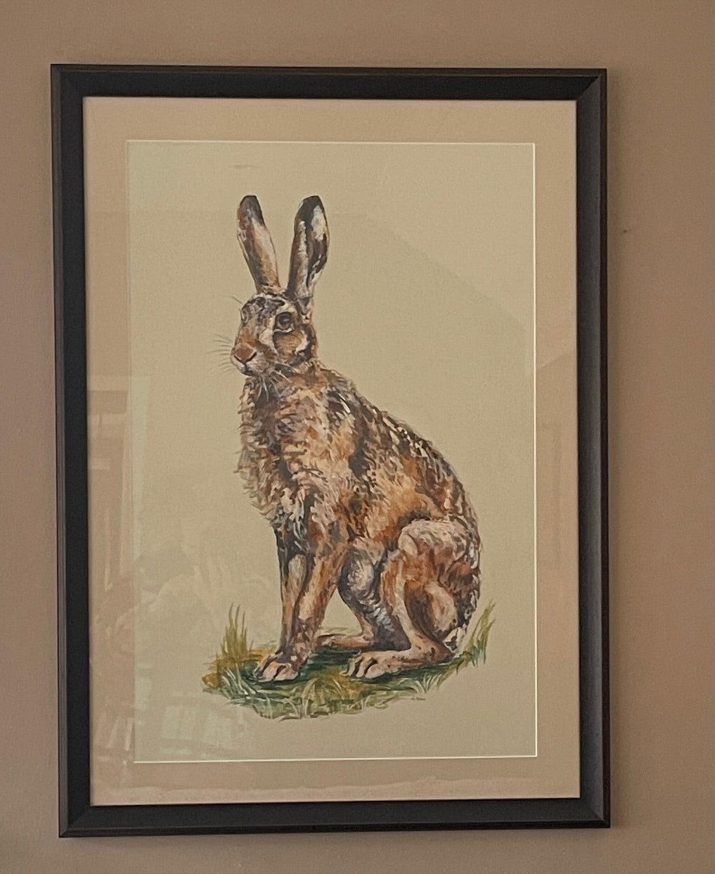 Hares are so athletic with their powerful hind legs ready to propel them off into the distance. There is something magical about catching a glimpse of a hare.  This painting has an off-white background.
