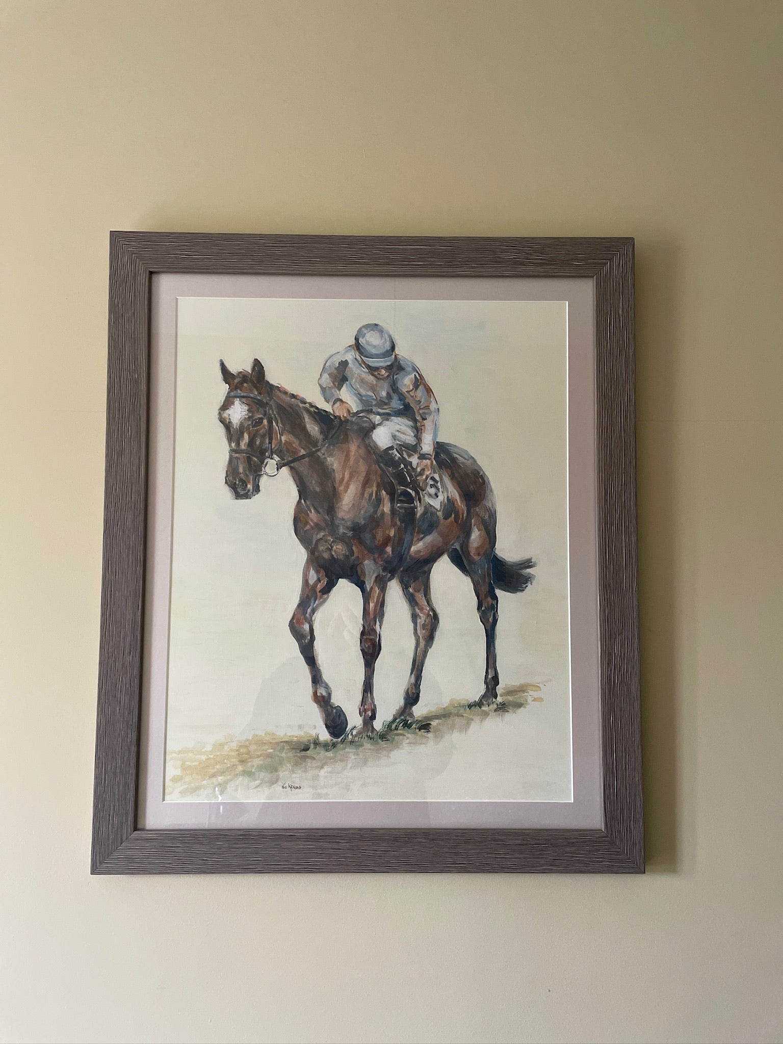 This painting is the study of a jockey checking his girth before the start of the race. The composition is from an interesting angle of perspective and the muted palette accentuates the quiet ritual of the preparatory checks before the thrilling act of horseracing. 