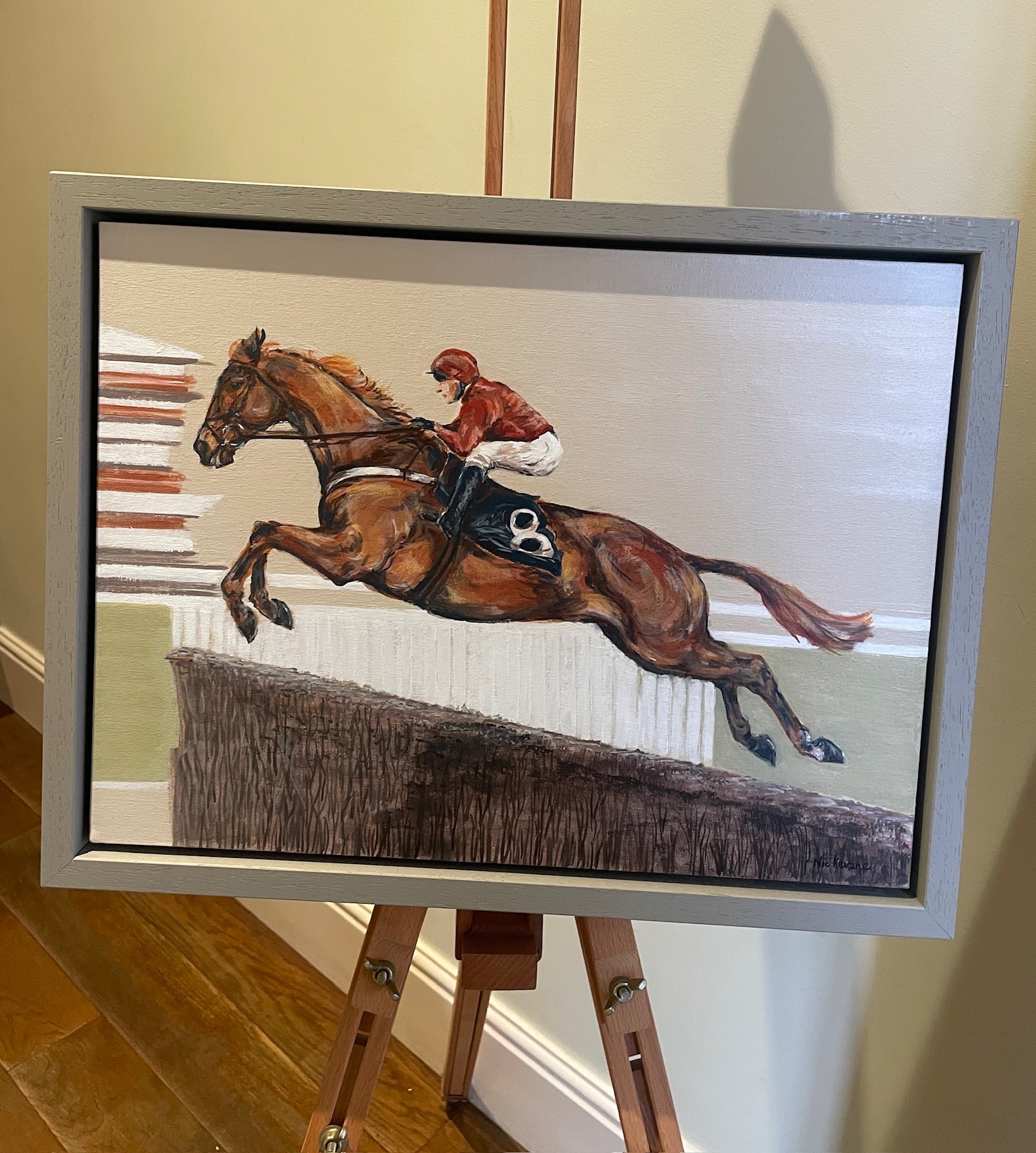 This painting has a racehorse over jumps as the subject.  Power Surge depicts the power of the horse jumping at speed.